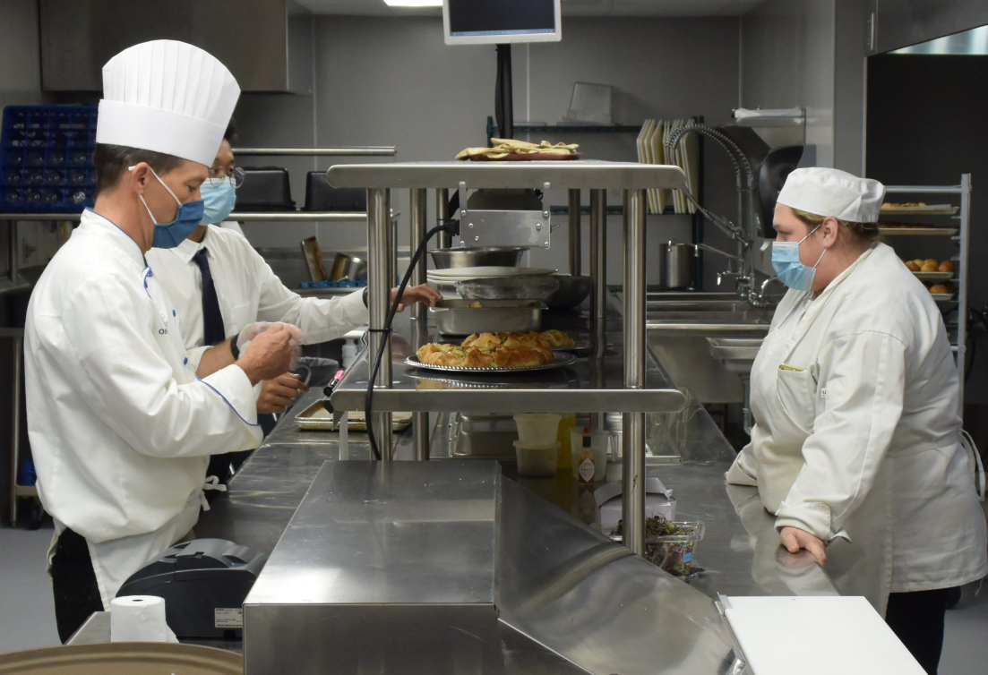 Hospitality Management Chef James Taylor (left) and students cooked up an amazing buffet for employees who are Veterans.