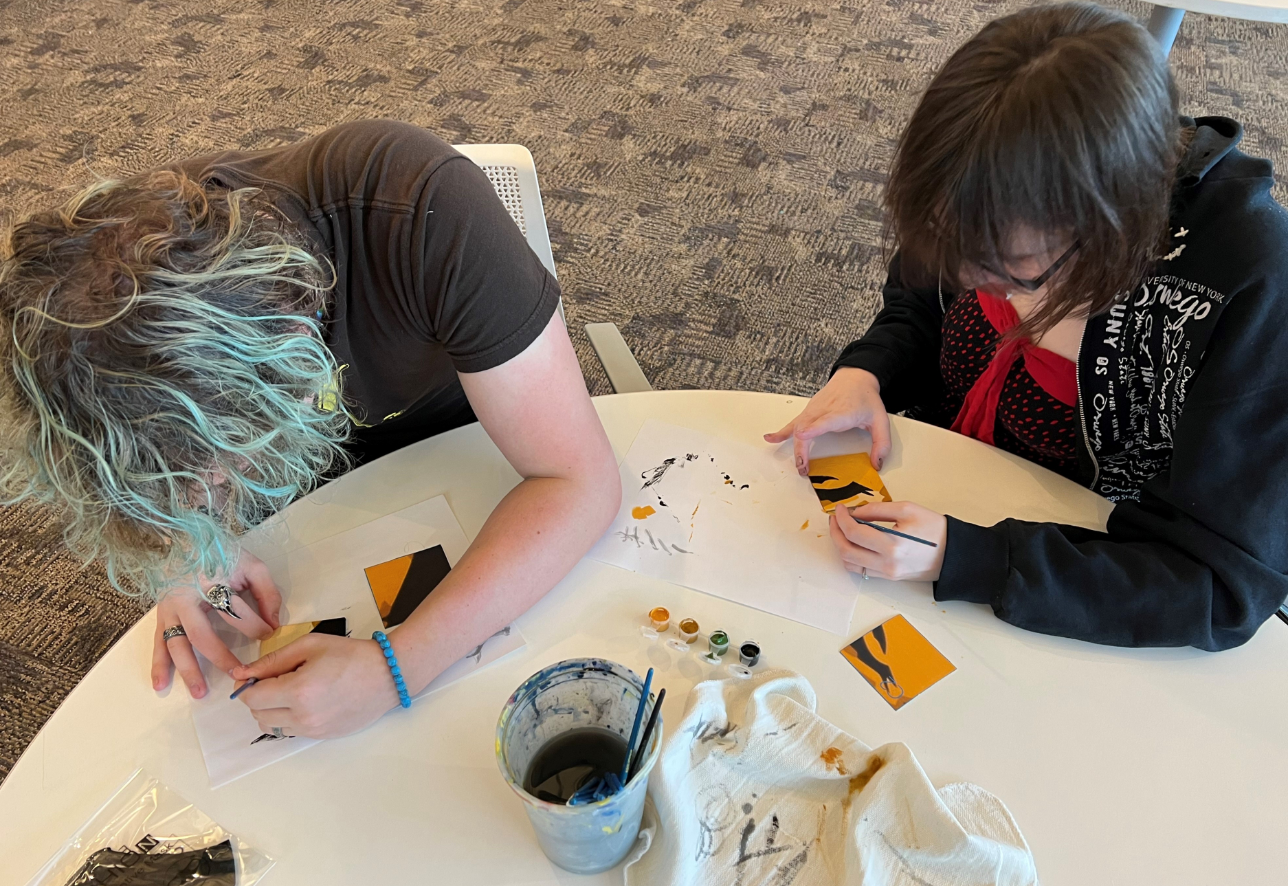 Students paint tiles for the Bob Marley mosaic.