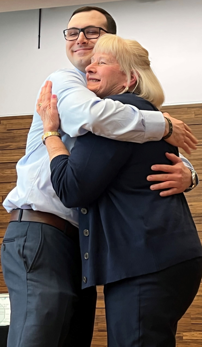 Greg Kranz (left) hugged his mother Catherine (right) after she presented him with his Nursing pin.