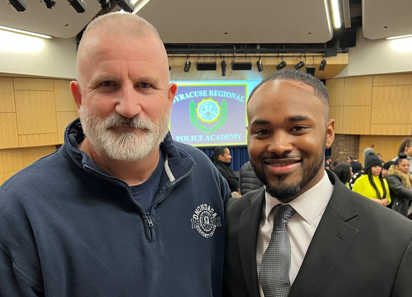 New Syracuse City Police Officer DeJuan Tigner Jr. (right) with OCC Criminal Justice Professor Pete Patnode (left).