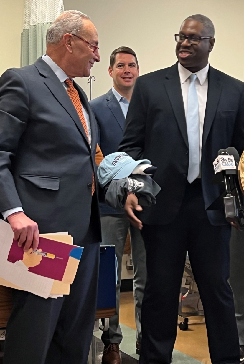 OCC President Dr. Warren Hilton (right) gave Senator Chuck Schumer (left) and OCC cap, shirt, and socks.