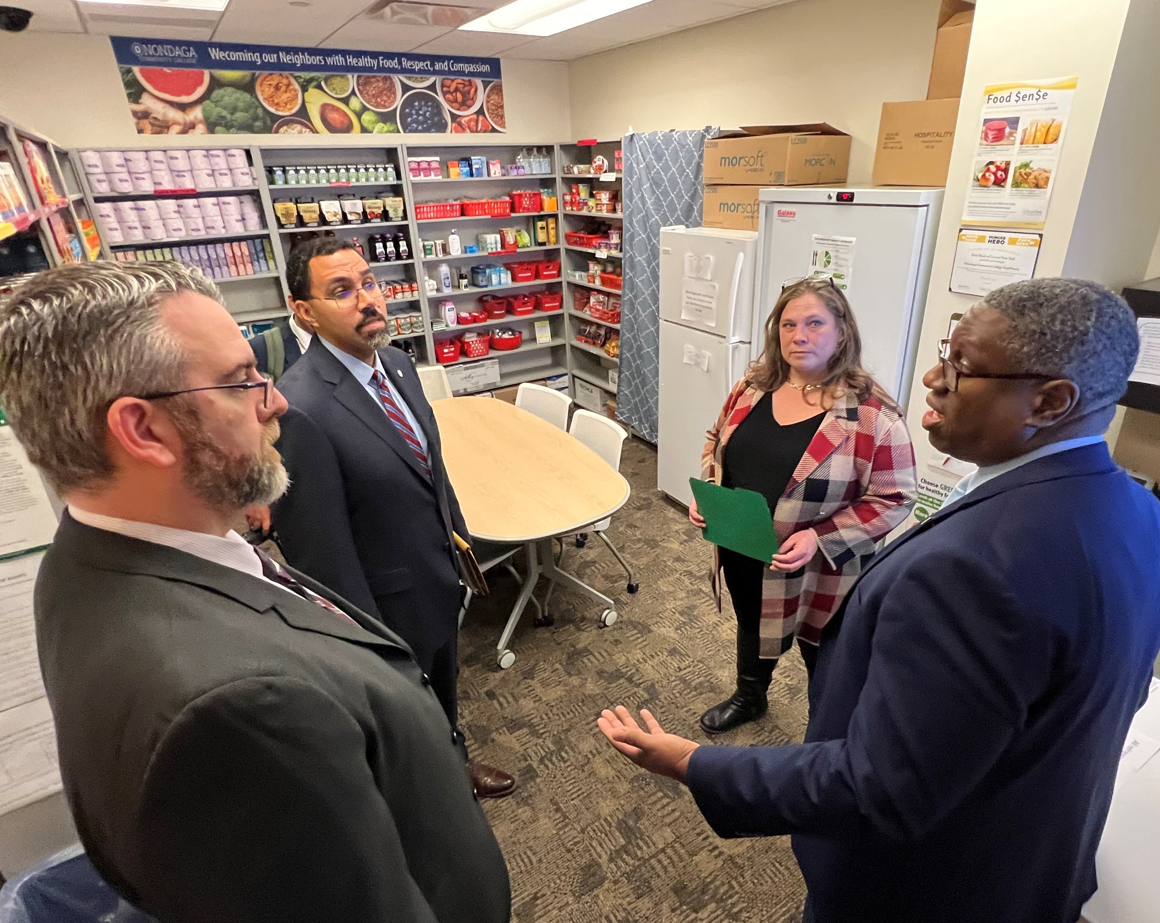 Pictured in the food pantry in the Community Care Hub are (clockwise left to right) OCC's Scott Schuhert, Chancellor King, OCC's Erika Sheets, and OCC President Dr. Warren Hilton.